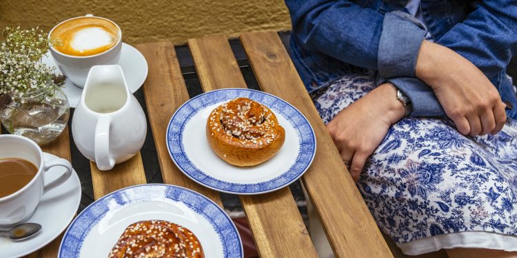 Enjoying Swedish Pastry Kanelbulle And Coffee